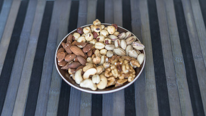 Healthy food. Nuts mix assortment on stone texture top view. Collection of different legumes for background image close up nuts, pistachios, almond, cashew nuts, peanut, walnut. image