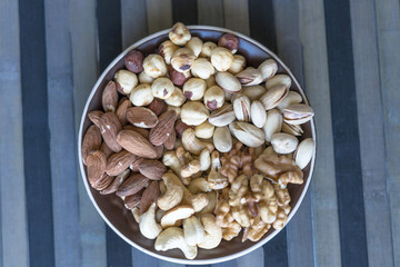Healthy food. Nuts mix assortment on stone texture top view. Collection of different legumes for background image close up nuts, pistachios, almond, cashew nuts, peanut, walnut. image