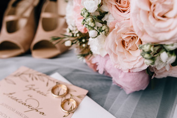 Beautiful decorated wedding invitations and wedding rings