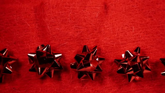 Shiny decorative bows on red background. Festive christmas border frame