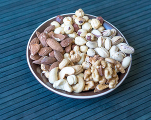 Healthy food. Nuts mix assortment on stone texture top view. Collection of different legumes for background image close up nuts, pistachios, almond, cashew nuts, peanut, walnut. image