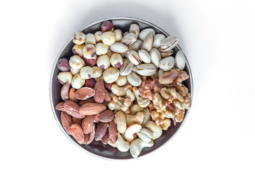 Healthy food. Nuts mix assortment on white grey table top view. Collection of different legumes for background image close up nuts, pistachios, almond, cashew nuts, peanut, walnut. image