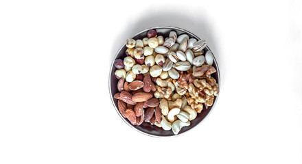Healthy food. Nuts mix assortment on white grey table top view. Collection of different legumes for background image close up nuts, pistachios, almond, cashew nuts, peanut, walnut. image