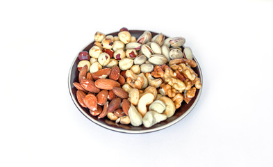 Healthy food. Nuts mix assortment on white grey table top view. Collection of different legumes for background image close up nuts, pistachios, almond, cashew nuts, peanut, walnut. image