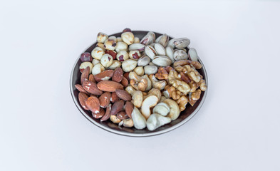 Healthy food. Nuts mix assortment on white grey table top view. Collection of different legumes for background image close up nuts, pistachios, almond, cashew nuts, peanut, walnut. image