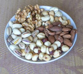 Healthy food. Nuts mix assortment on stone texture top view. Collection of different legumes for background image close up nuts, pistachios, almond, cashew nuts, peanut, walnut. image