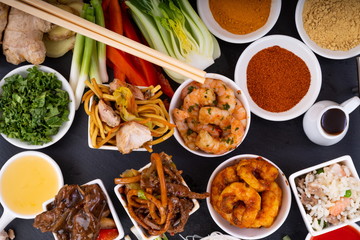 Asian Food and Ingredients Selection.  Selection of Asian food and ingredients ready for preparation of a meal, presented on a slate platter.