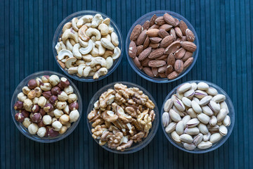 Healthy food. Nuts mix assortment on stone texture top view. Collection of different legumes for background image close up nuts, pistachios, almond, cashew nuts, peanut, walnut. image