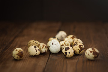 several quail eggs on wooden background