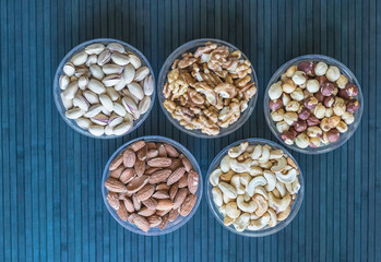 Healthy food. Nuts mix assortment on stone texture top view. Collection of different legumes for background image close up nuts, pistachios, almond, cashew nuts, peanut, walnut. image