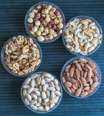 Healthy food. Nuts mix assortment on stone texture top view. Collection of different legumes for background image close up nuts, pistachios, almond, cashew nuts, peanut, walnut. image