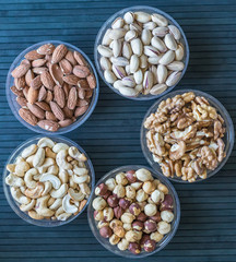Healthy food. Nuts mix assortment on stone texture top view. Collection of different legumes for background image close up nuts, pistachios, almond, cashew nuts, peanut, walnut. image