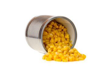 Canned corn on a white background. Corn closeup in an iron jar on a white background.