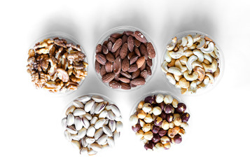 Healthy food. Nuts mix assortment on white grey table top view. Collection of different legumes for background image close up nuts, pistachios, almond, cashew nuts, peanut, walnut. image