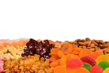 Mix of nuts and dried fruits and sweet turkish delights isolated on white.