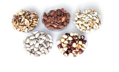 Healthy food. Nuts mix assortment on white grey table top view. Collection of different legumes for background image close up nuts, pistachios, almond, cashew nuts, peanut, walnut. image