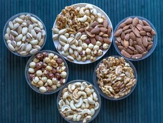 Healthy food. Nuts mix assortment on stone texture top view. Collection of different legumes for background image close up nuts, pistachios, almond, cashew nuts, peanut, walnut. image