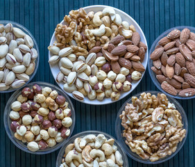 Healthy food. Nuts mix assortment on stone texture top view. Collection of different legumes for background image close up nuts, pistachios, almond, cashew nuts, peanut, walnut. image