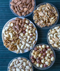 Healthy food. Nuts mix assortment on stone texture top view. Collection of different legumes for background image close up nuts, pistachios, almond, cashew nuts, peanut, walnut. image
