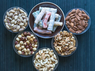 Oriental dessert halva with pistachio, almond, cashew nuts, peanut, walnut  on a  plate. Image. Healthy food. Nuts mix assortment. sweets, Turkish Delight. Isolated  background.. Eastern delicacy