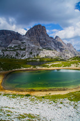 Scenic landscape panoramic view of idyllic mountains and lakes scene in summer on Tre Cime di Lavaredo(Drei Zinnen) hiking/walking trail in Sexten Dolomites, Italy. Beautiful alpine panorama.