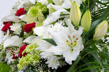 Beautiful floral background, red and white flowers closeup. White and green chrysanthemum, red rose, lily, Gypsоphila and Calla.
