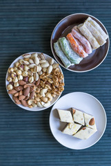  Oriental dessert halva with pistachio, almond, cashew nuts, peanut, walnut  on a  plate. Image. Healthy food. Nuts mix assortment. sweets, Turkish Delight. Isolated  background.. Eastern delicacy