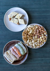 Oriental dessert halva with pistachio, almond, cashew nuts, peanut, walnut  on a  plate. Image. Healthy food. Nuts mix assortment. sweets, Turkish Delight. Isolated  background.. Eastern delicacy