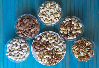 Healthy food. Nuts mix assortment on texture top view. Collection of different legumes for background image close up nuts, pistachios, almond, cashew nuts, peanut, walnut. image