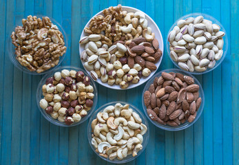 Healthy food. Nuts mix assortment on texture top view. Collection of different legumes for background image close up nuts, pistachios, almond, cashew nuts, peanut, walnut. image