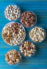 Healthy food. Nuts mix assortment on texture top view. Collection of different legumes for background image close up nuts, pistachios, almond, cashew nuts, peanut, walnut. image