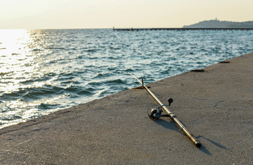 Fototapeta na wymiar Fishing rod on beach