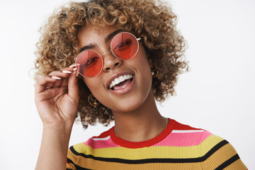 Hey you wanna have fun. Portrait of cool and stylish joyful african american party girl with blond...