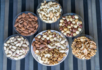 Healthy food. Nuts mix assortment on texture top view. Collection of different legumes for background image close up nuts, pistachios, almond, cashew nuts, peanut, walnut. image