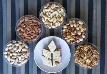 Oriental dessert halva with pistachio, almond, cashew nuts, peanut, walnut  on a  plate. Image. Healthy food. Nuts mix assortment. closeup of sweets Delight. background. . Eastern delicacy