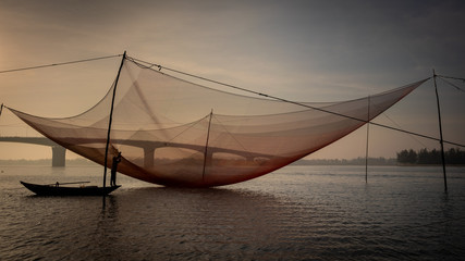 Traditional fishing net on the Thu Bon River near Hoi An, Vietnam