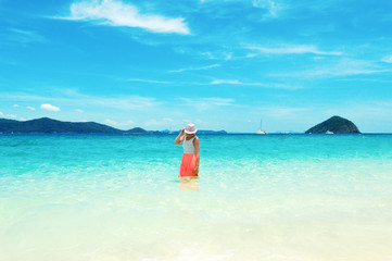 Fototapeta na wymiar Thailand's islands seascape view, with a young woman traveler on vacation in model pose