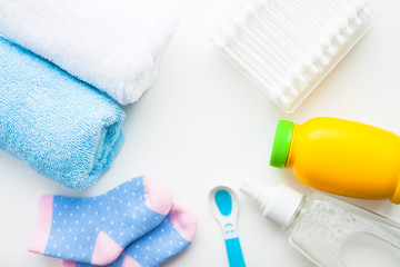Obraz na płótnie Canvas Newborn baby story. Towels and children's toys, scissors, baby bottle, nipple, hairbrush on white background
