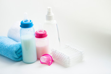 Newborn baby story. Towels and children's toys, scissors, baby bottle, nipple, hairbrush on white background