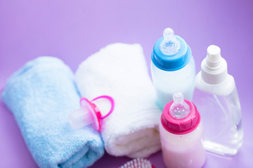 Obraz na płótnie Canvas Newborn baby story. Towels and children's toys, scissors, baby bottle, nipple, hairbrush on white background