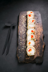 Tempura maki. Japanese sushi tempura roll on wooden platter. Japanese traditional fusion food style, restaurant menu