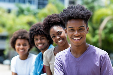 Laughing african american man with group of young adults in line
