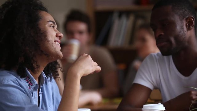 African guy and girl talking at meeting or first date