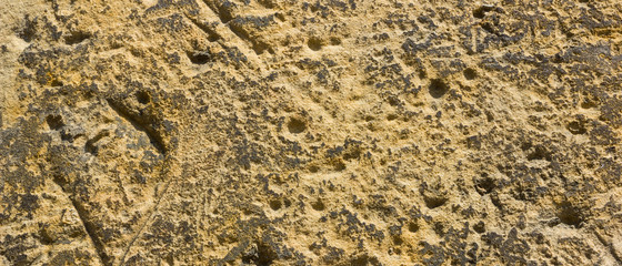 Background of the old wall. Texture of stone surface. Abstract background in retro style. Brown surface of solid material