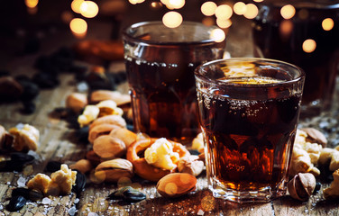 Cola glasses, sweet and savory snacks, old wooden table, unhealthy food, selective focus