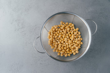 Top view of dry fresh chickpeas or garbanzo in sieve. Organic ingredient. Healthy product full of protein and vitamins. Garbanzo for vegans