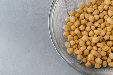 Close up shot of raw chickpeas in sieve. Healthy food. Roasted garbanzo. Eco vegetarian dish concept. Vegatable source of protein.