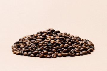 heap of coffee beans on paper background