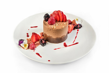 Round chocolate mousse cake. Two chocolate types blended in a delicious cake with berries