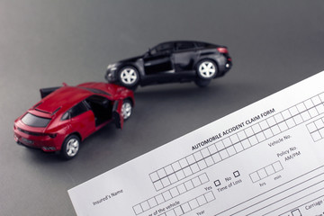 Car crash scene two broken cars and car insurance document. progressive car insurance concept. gray background